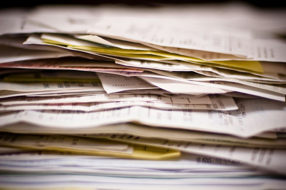 A stack of invoices, receipts and loose paperwork